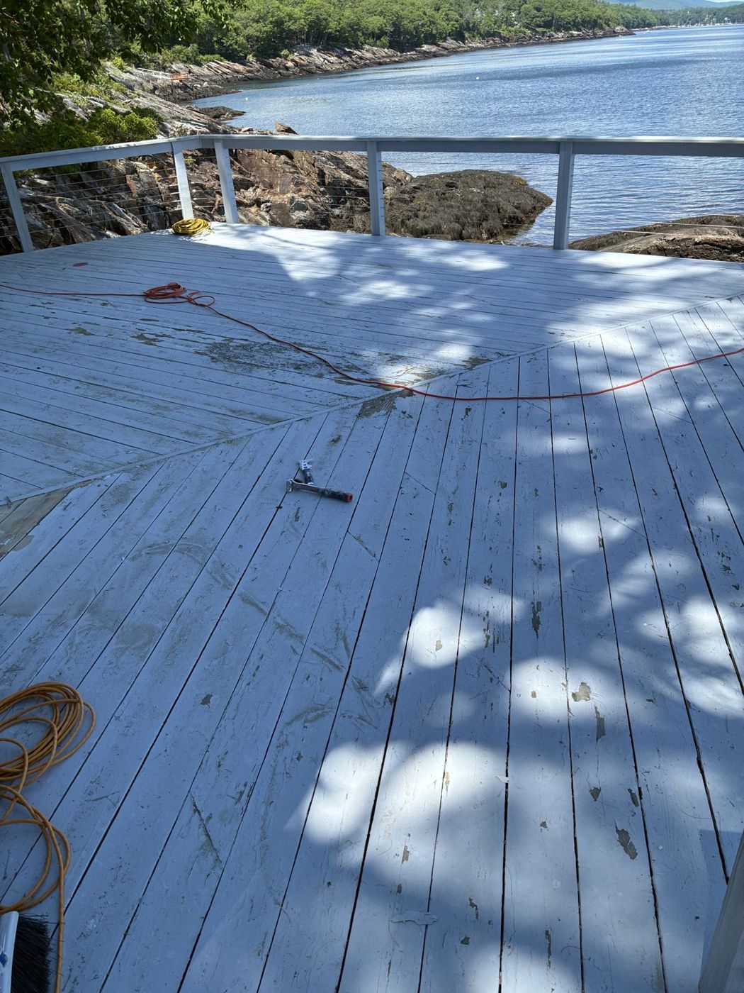 Weathered oceanfront deck before repainting
