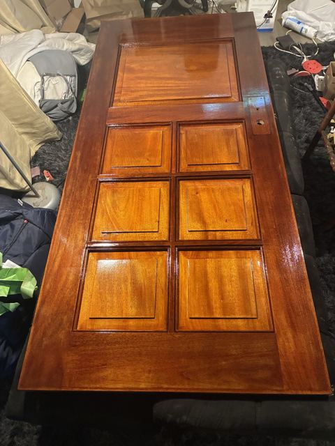 Six-panel mahogany door stained and varnished to a deep gloss