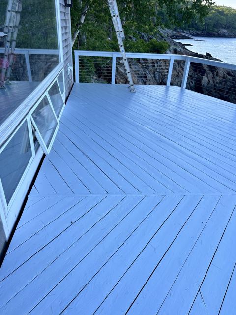Oceanfront deck painted white with cable railing