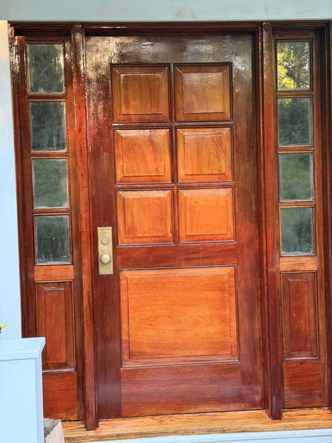 Stained and varnished entry door with glass sidelights